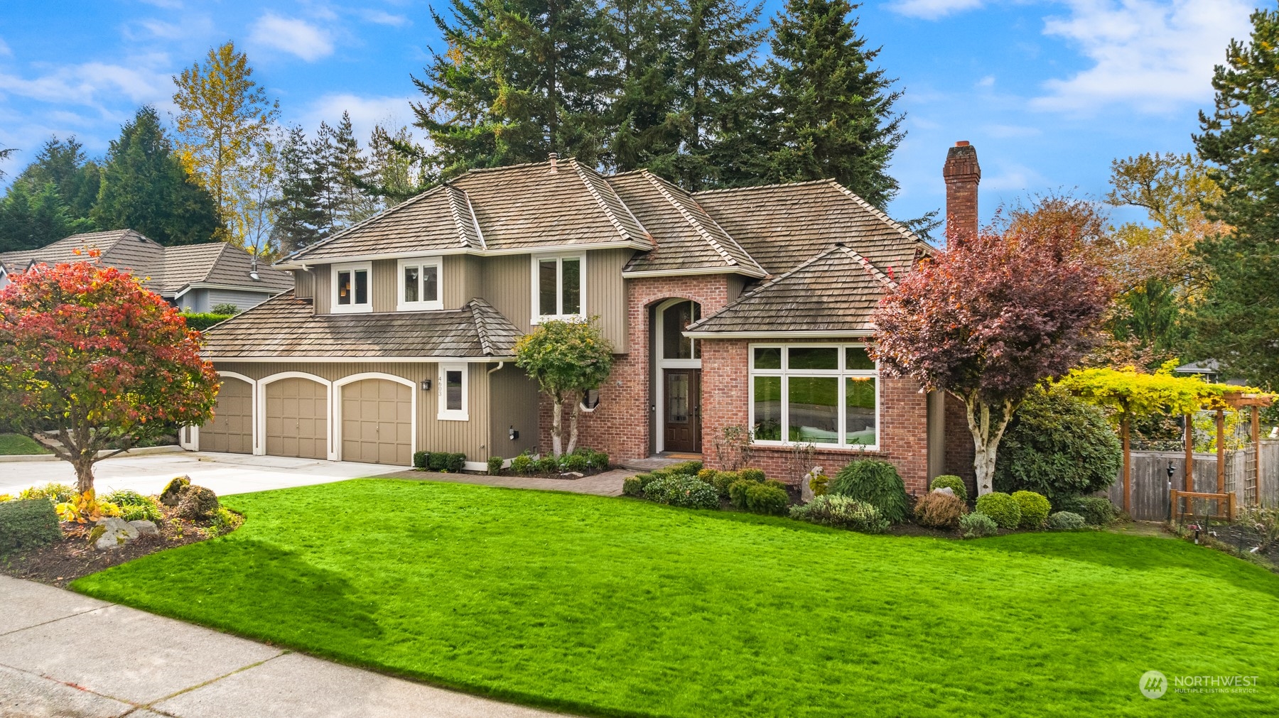 a front view of a house with a garden and plants