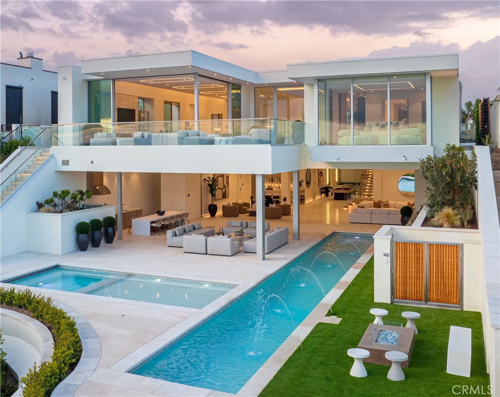 a view of a house with swimming pool and sitting area