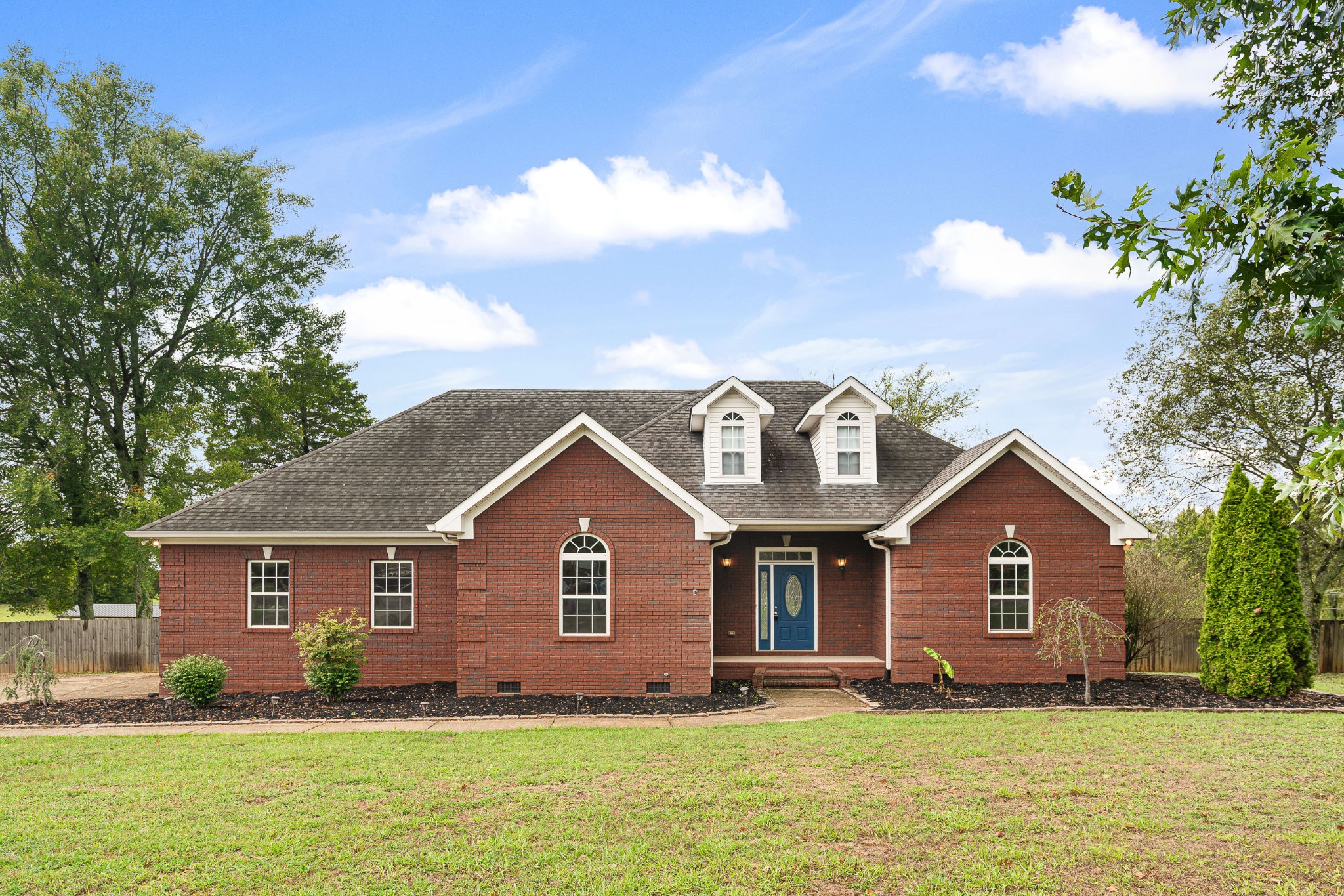 a front view of a house with a yard