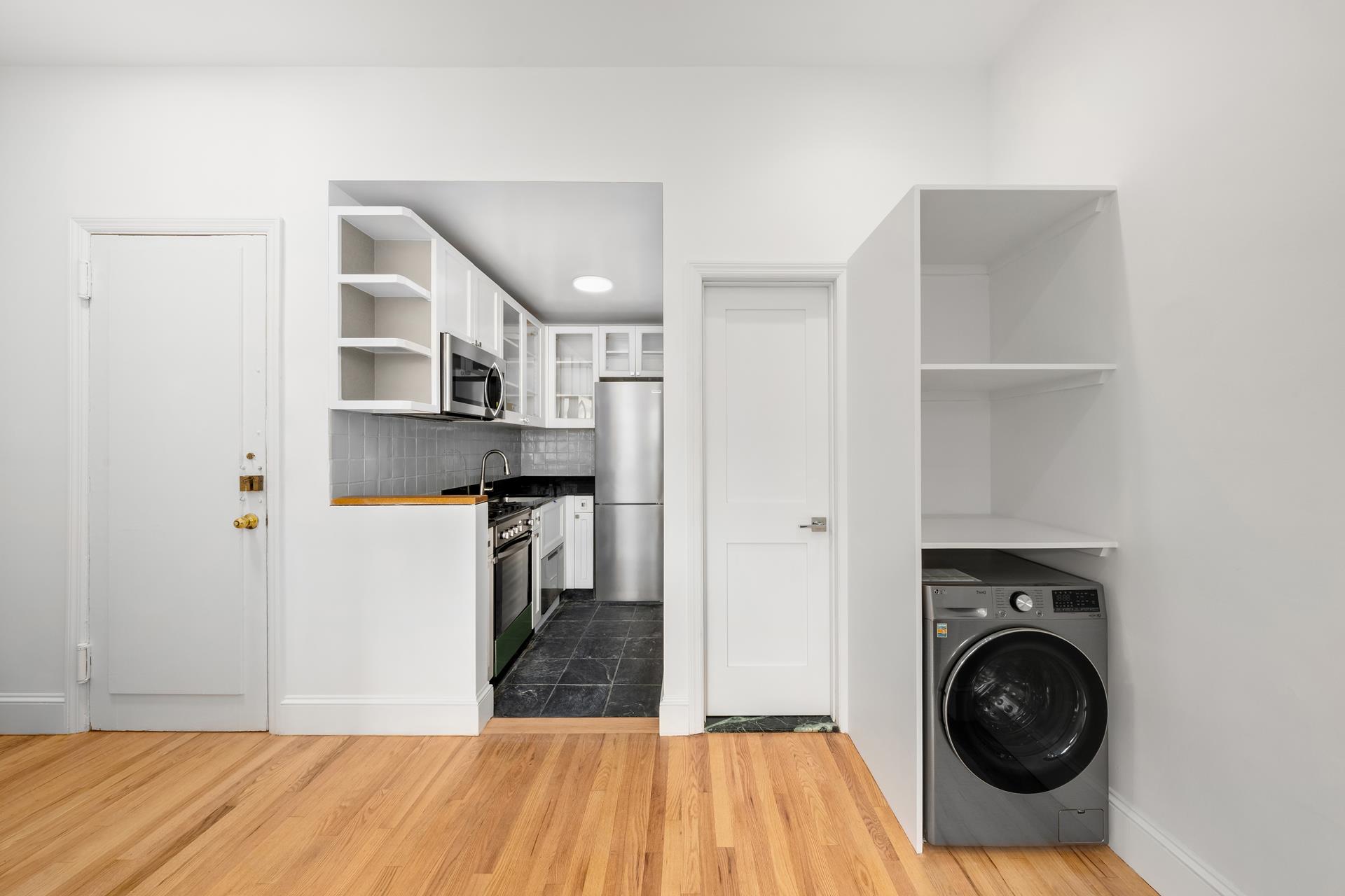 a kitchen with granite countertop a sink and a stove top oven