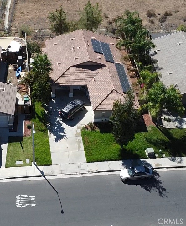 an aerial view of a house with a garden and parking space