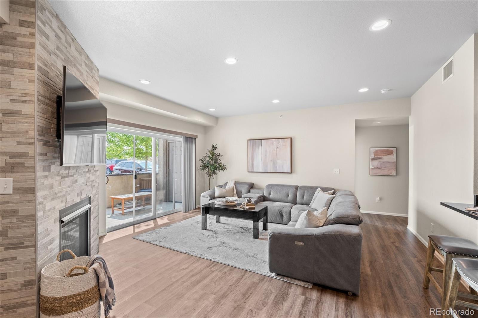 a living room with furniture and a fireplace