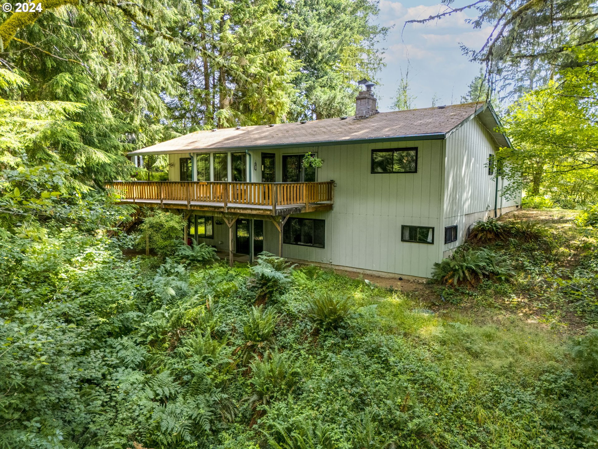 a view of house with yard and seating area