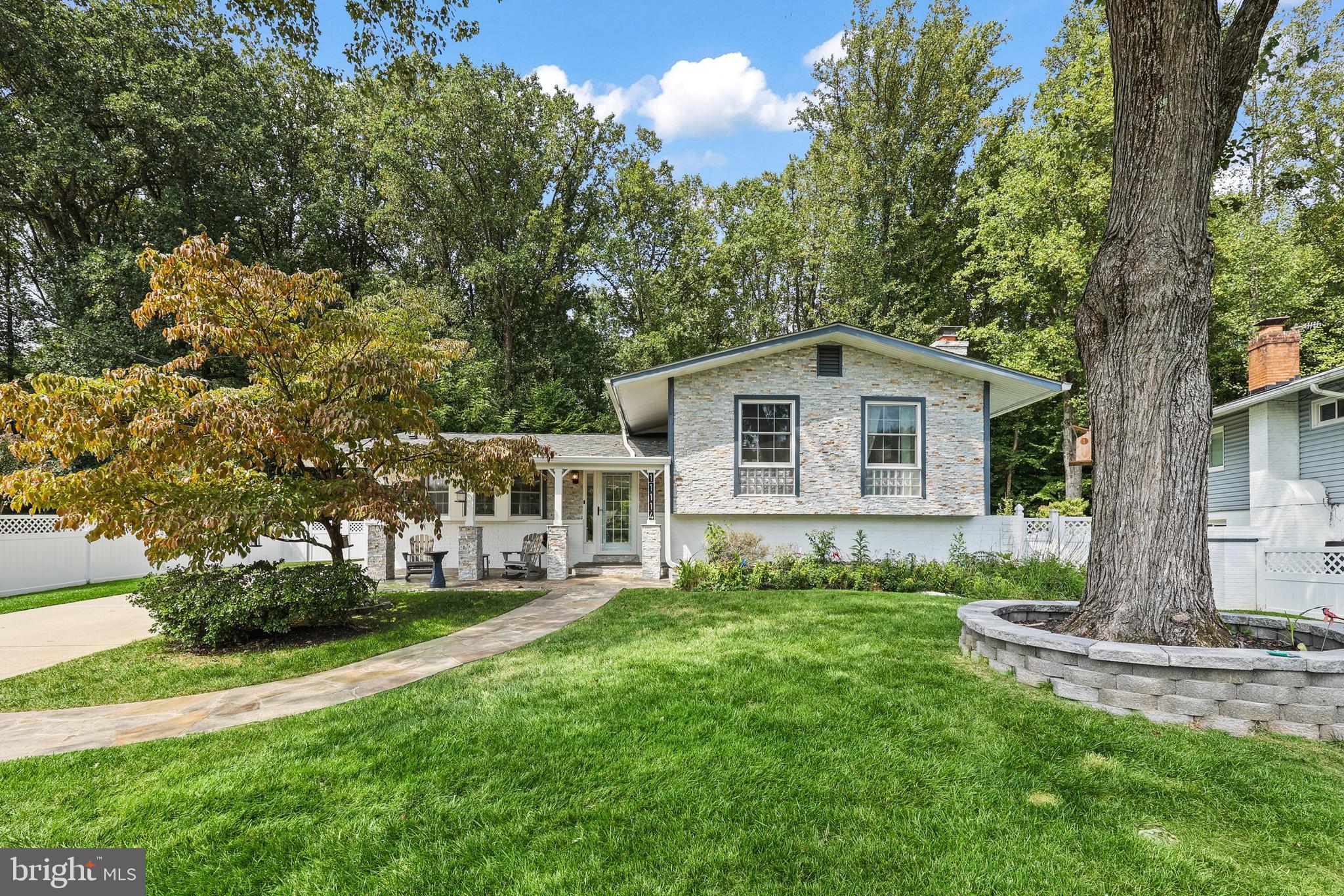 a view of a house with backyard and sitting area