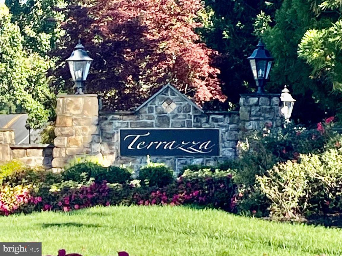 a sign that is sitting in front of flowers