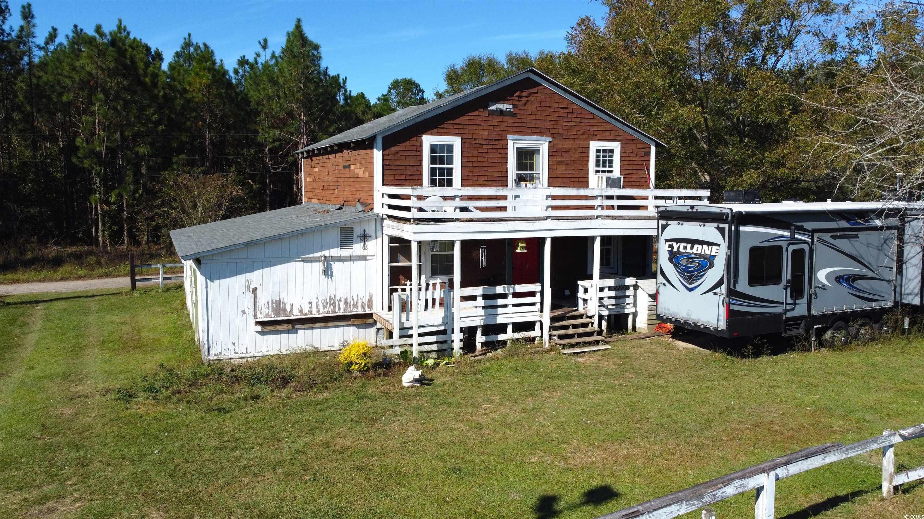 Front of cabin with a lawn and a porch