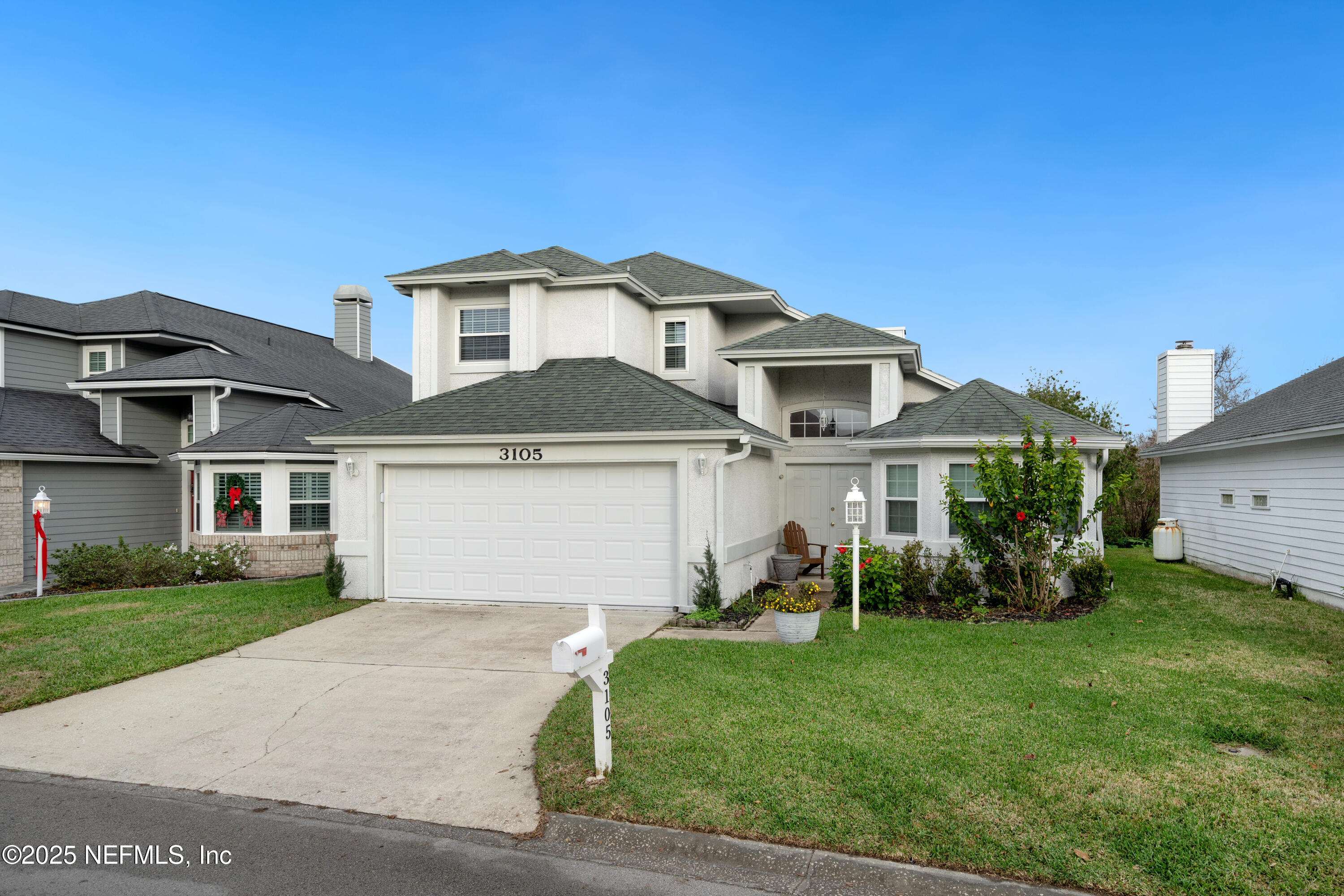 a front view of a house with a yard and garage