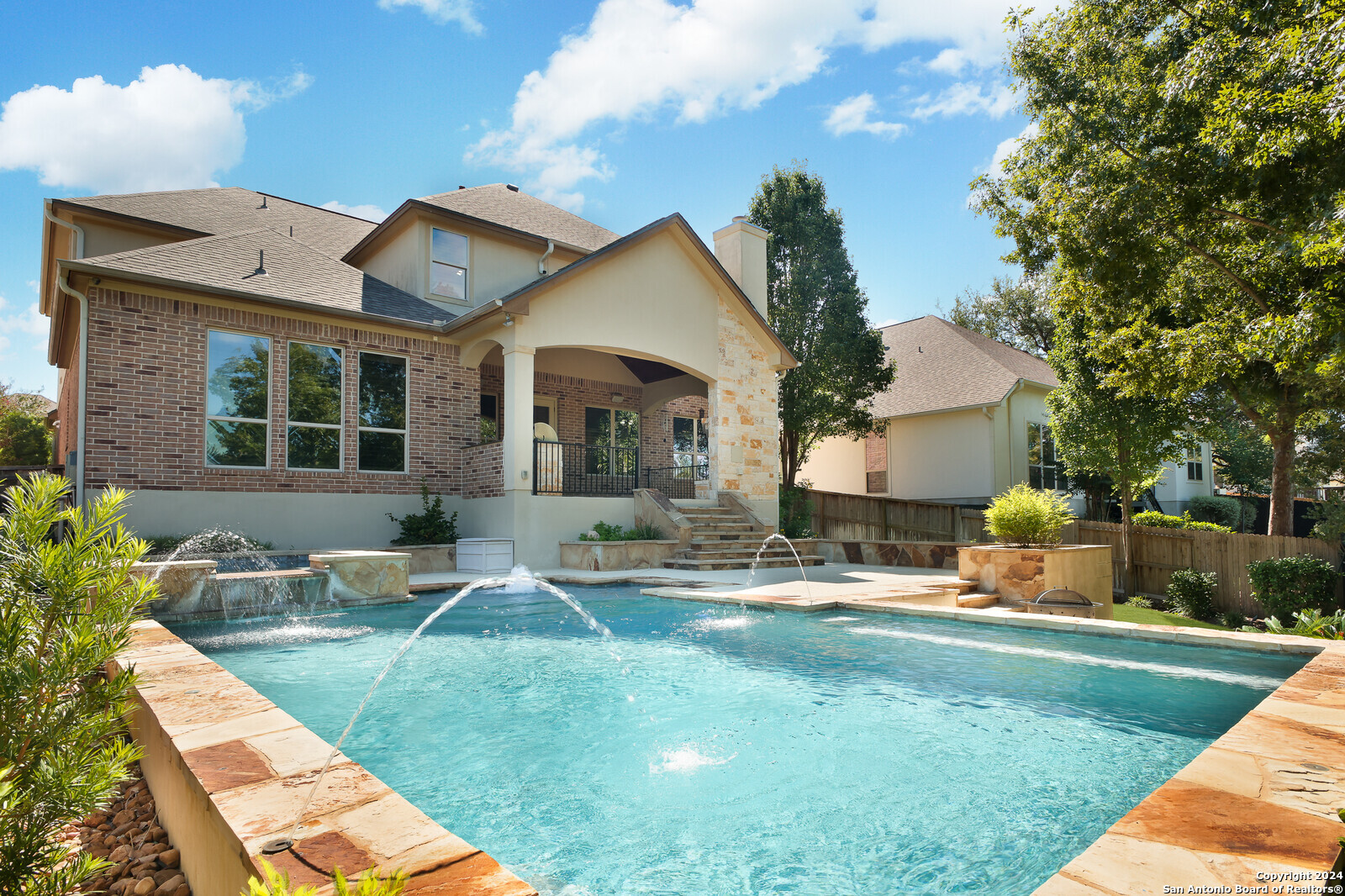 a house view with a sitting space and garden