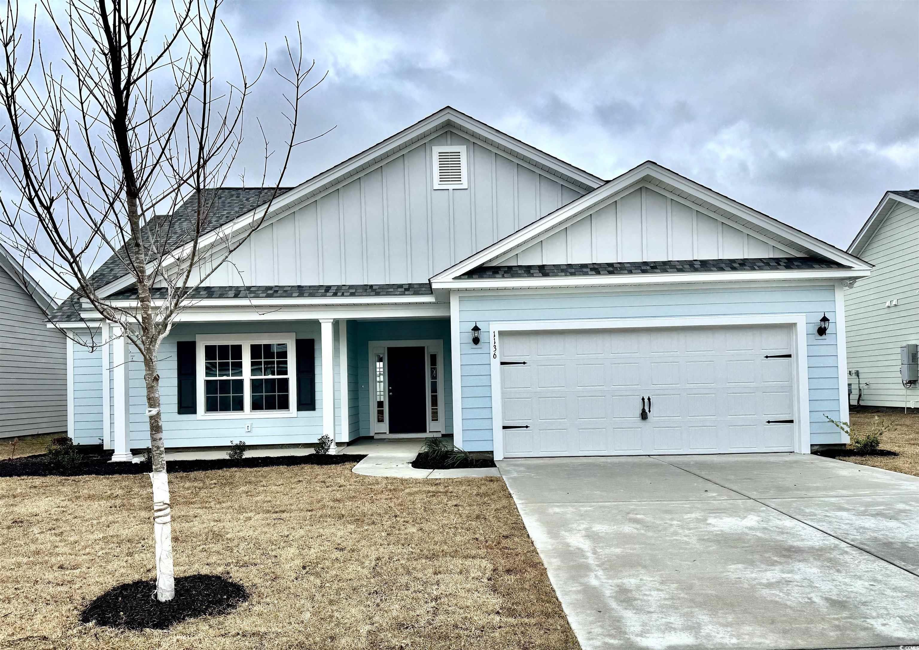 View of front of property with a garage, concrete