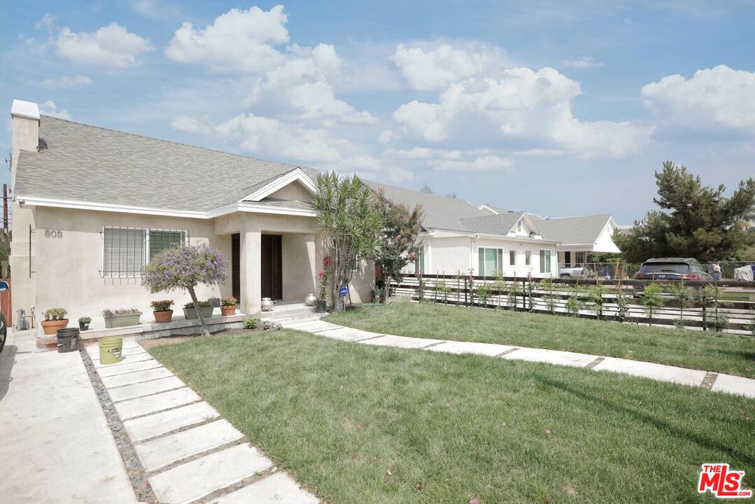 a front view of a house with a garden