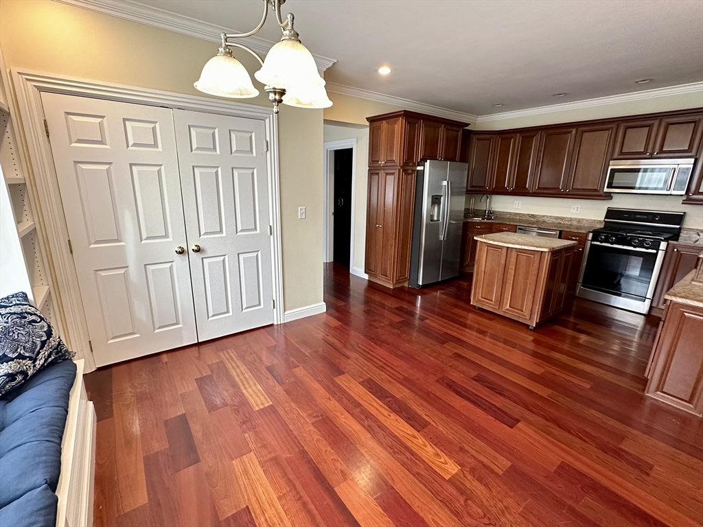 a kitchen with stainless steel appliances wooden floor and wooden floors