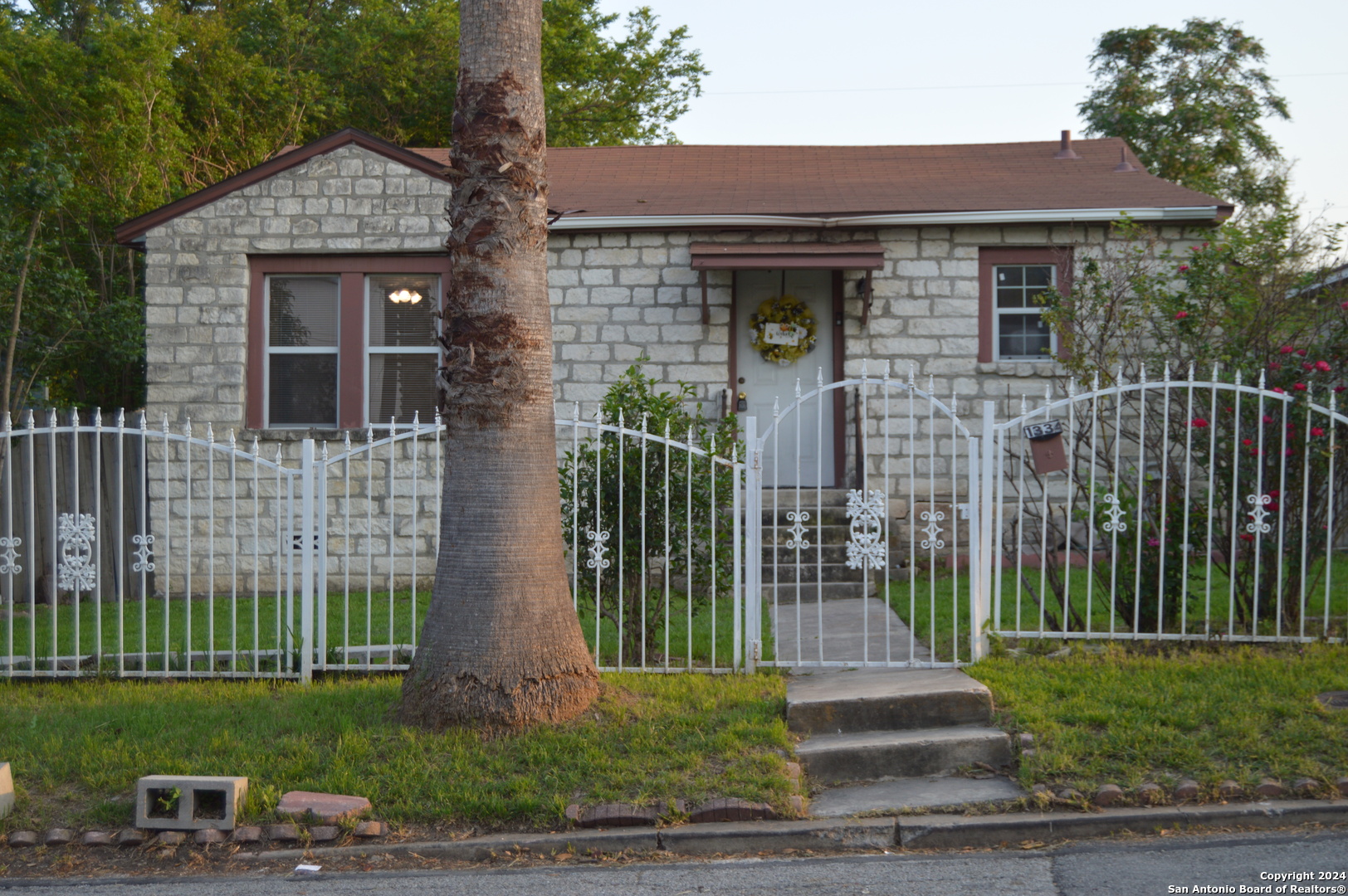 a front view of a house with garden