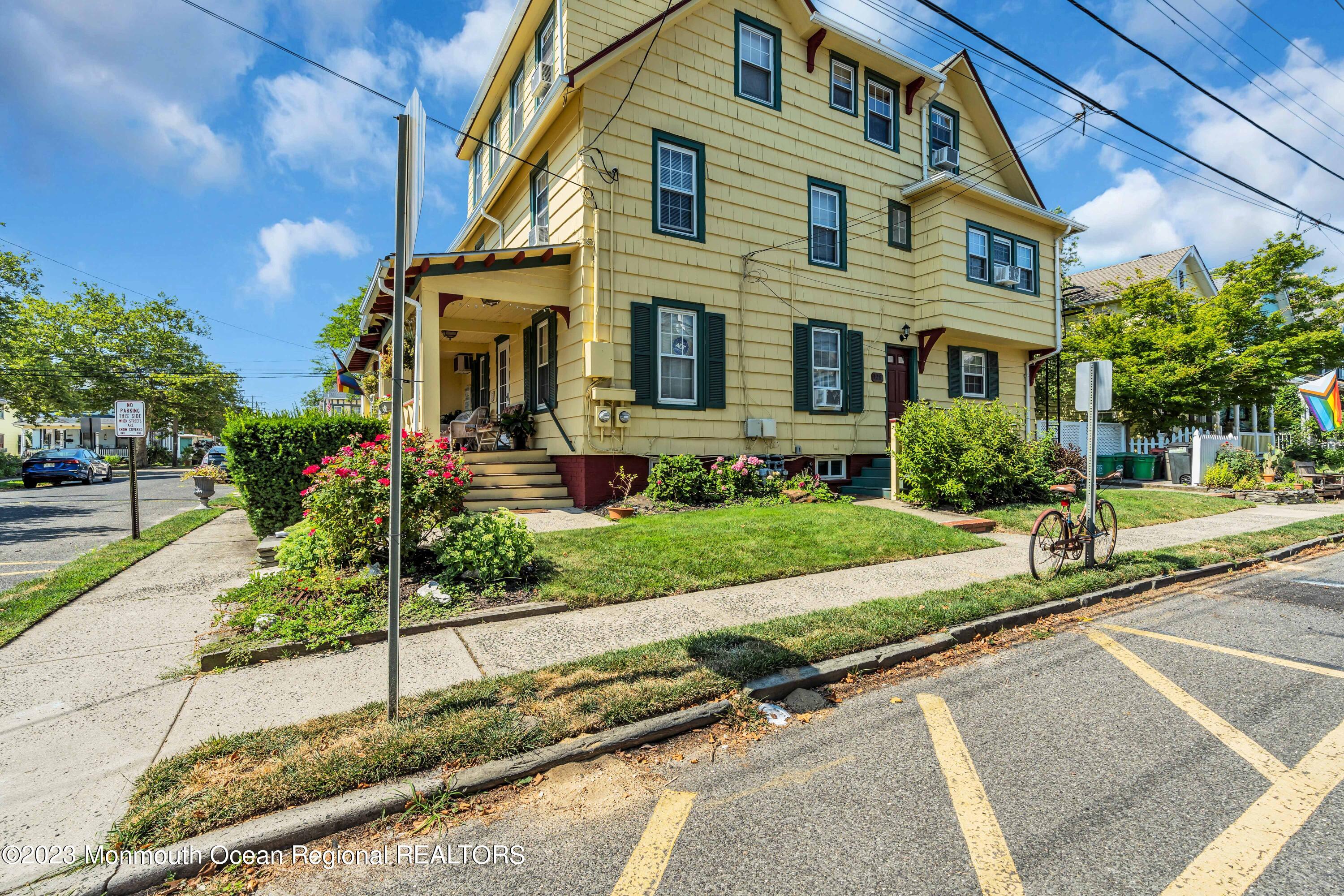 a front view of a house with a yard and outdoor seating