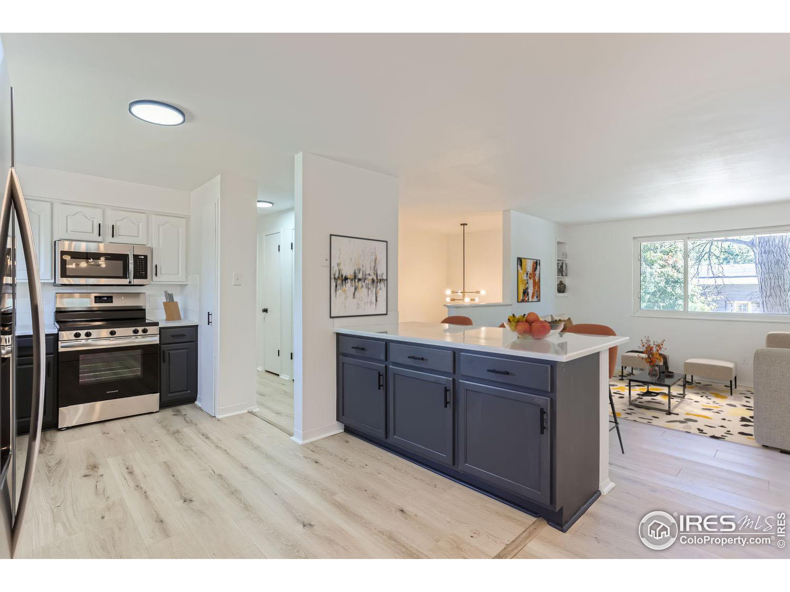 a kitchen with stainless steel appliances kitchen island granite countertop a stove a sink and a refrigerator