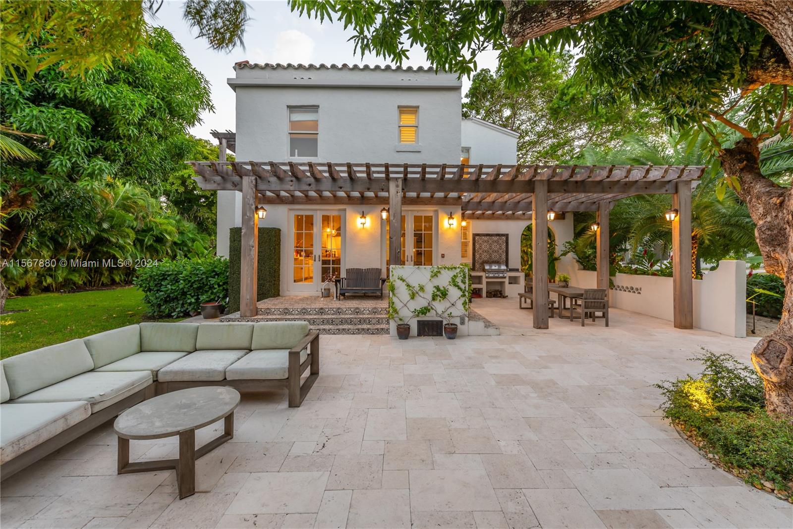 a view of a patio with dining table and chairs under an umbrella