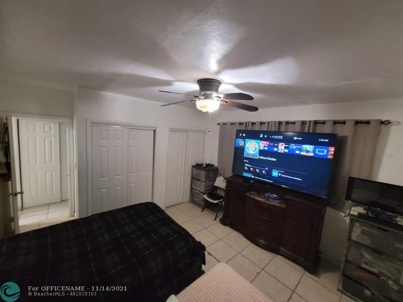 a living room with furniture a flat screen tv and a window