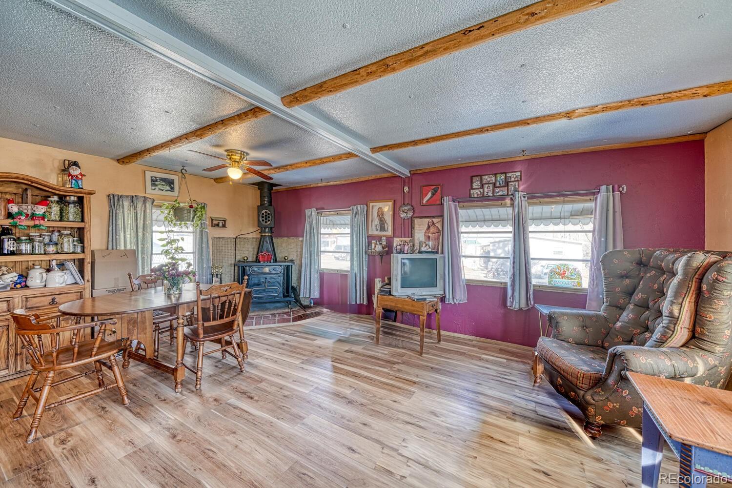 a living room with furniture a wooden floor and next to a window