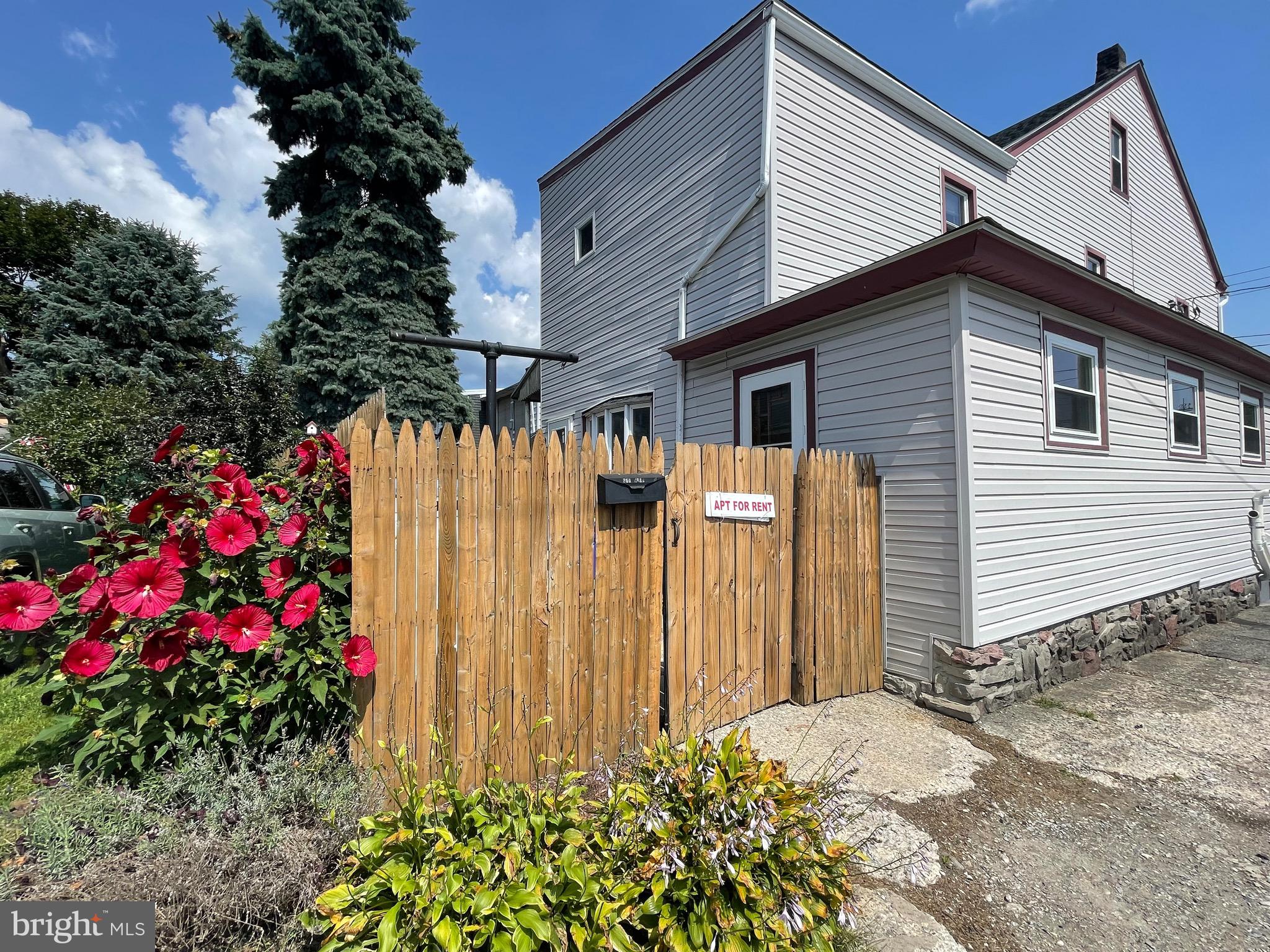 a view of a house with wooden fence