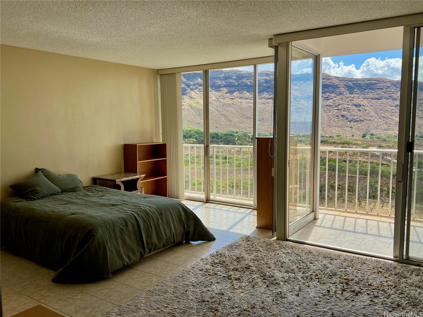 a bedroom with a large bed and a large window