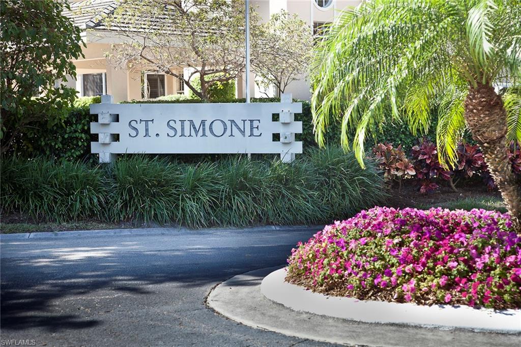 a view of a sign board with buildings