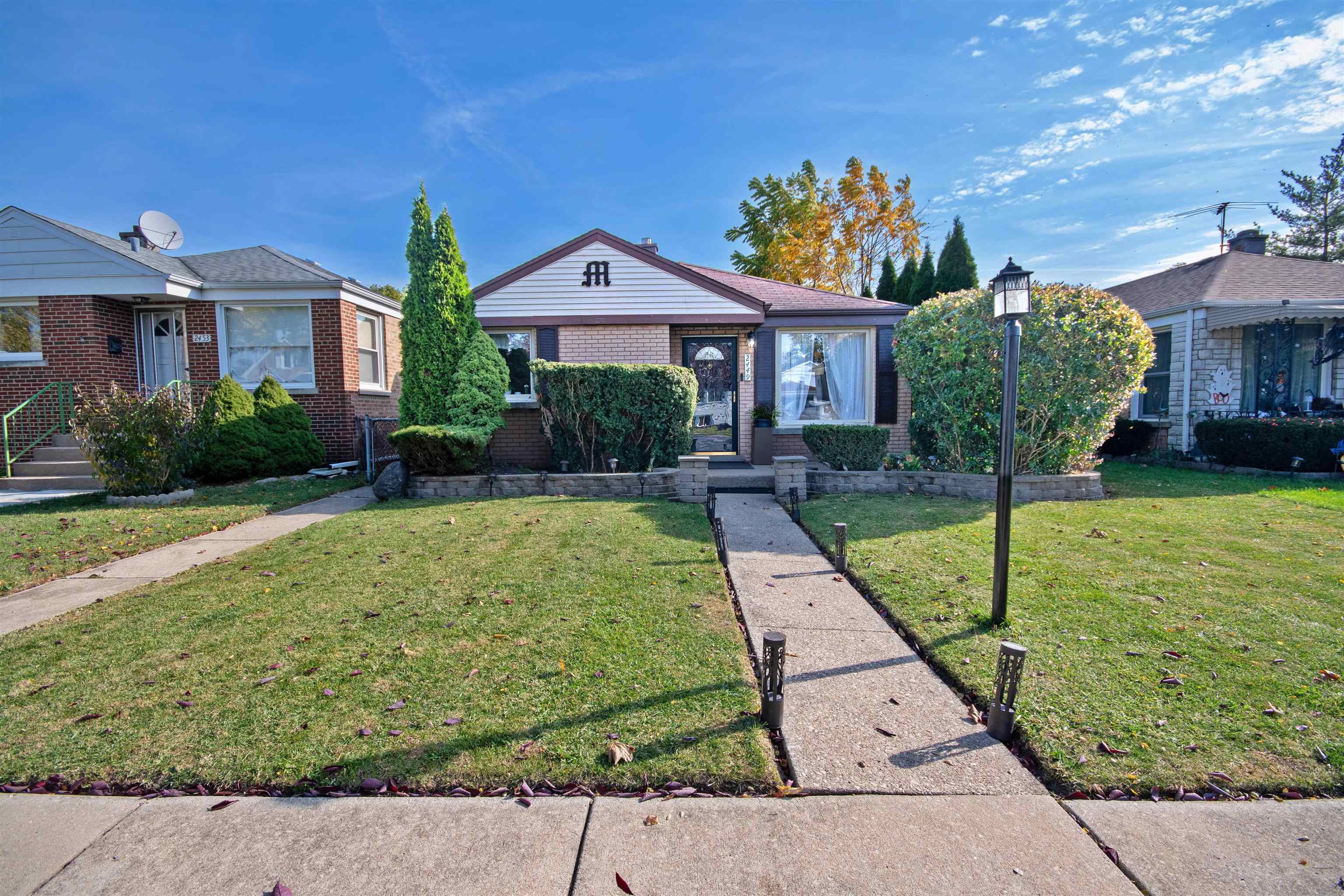 a front view of a house with garden