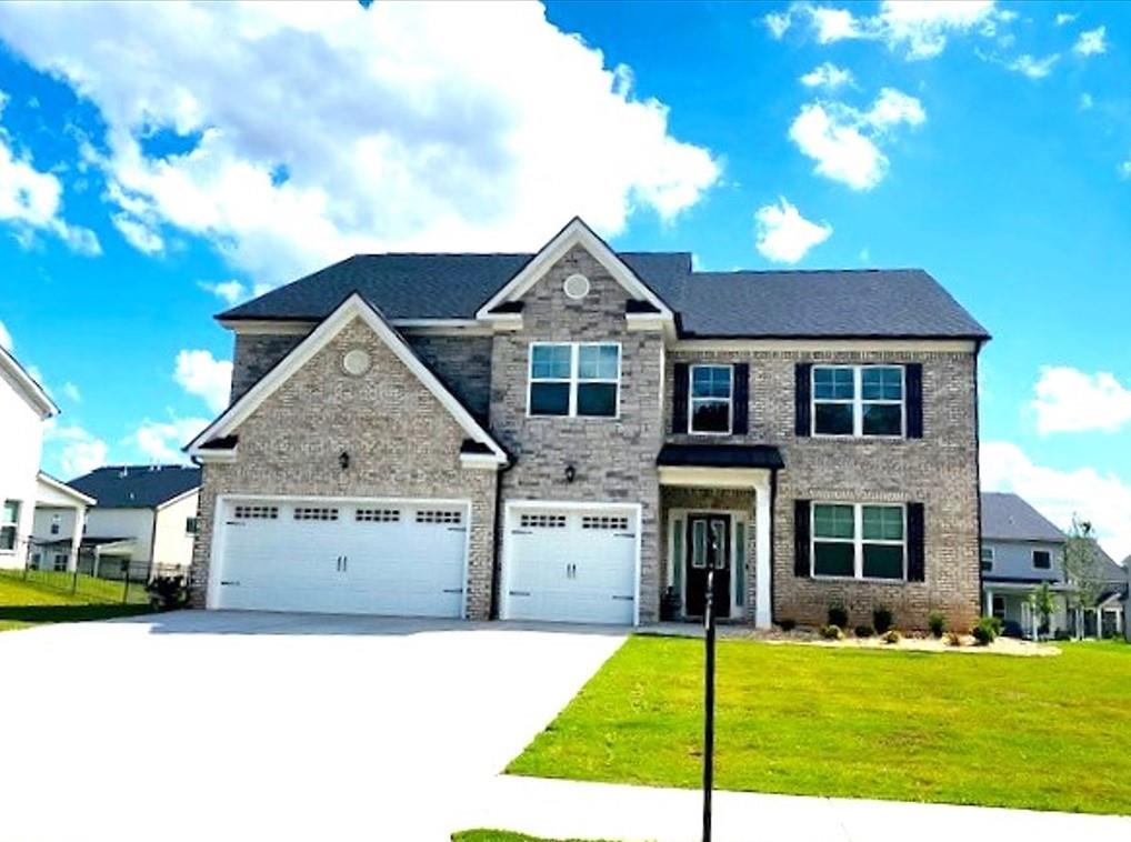 a front view of a house with a yard