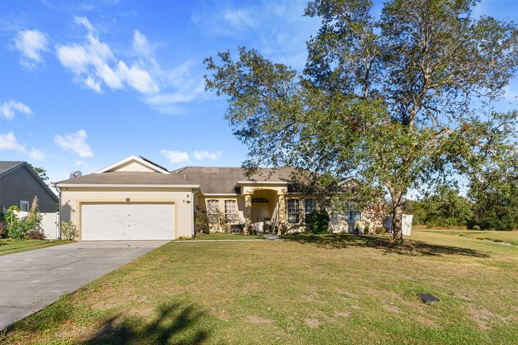 a front view of a house with a yard and garage