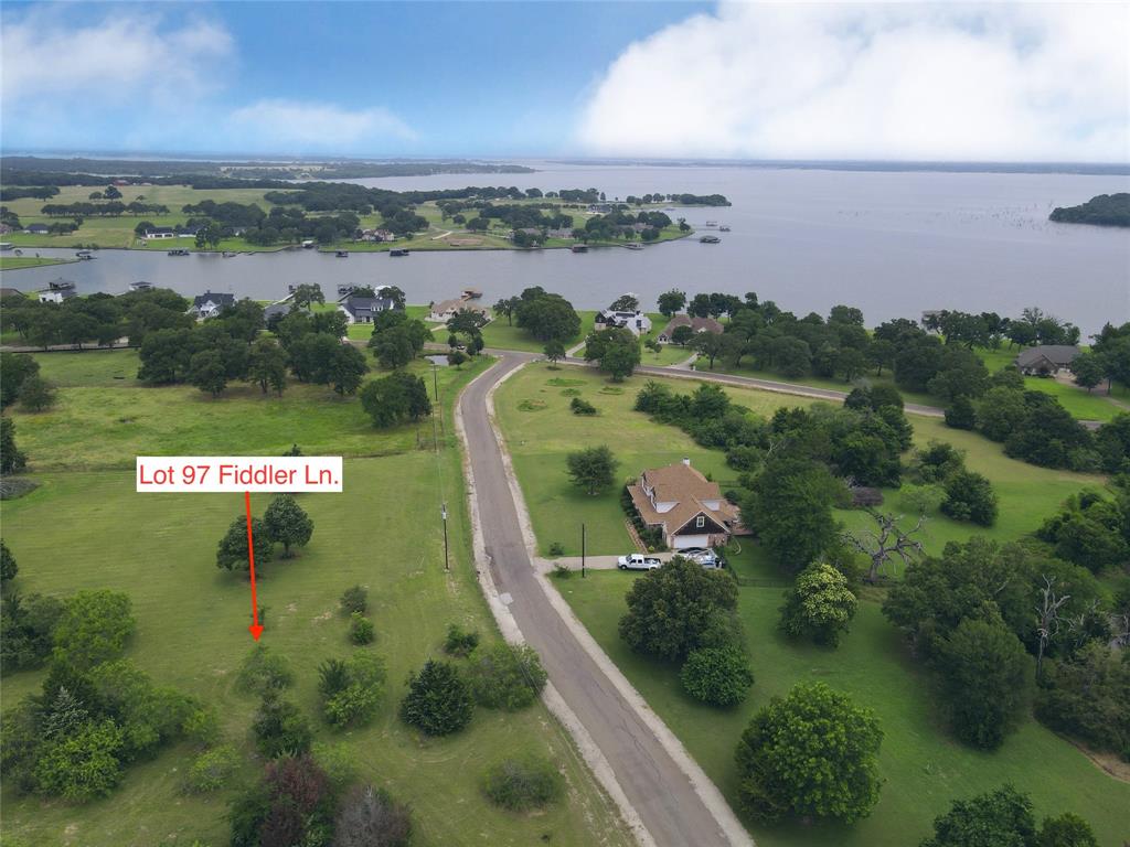 an aerial view of a golf course with a lake view