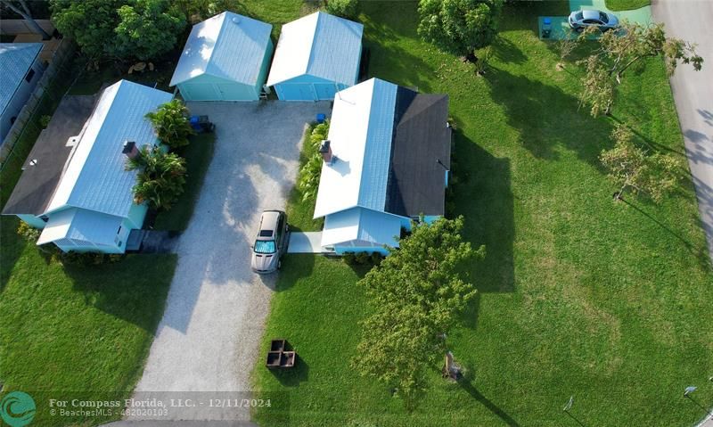 an aerial view of a house with a yard basket ball court and outdoor seating