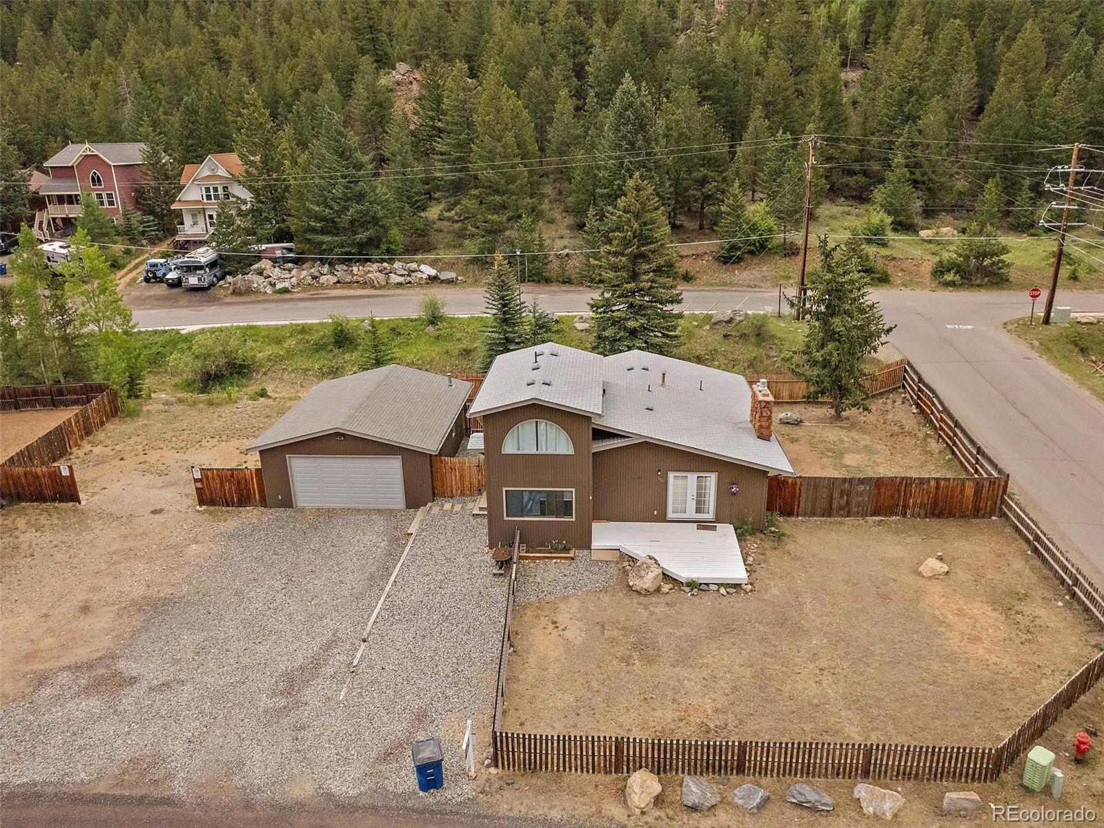 an aerial view of a house with a yard basket ball court and outdoor seating