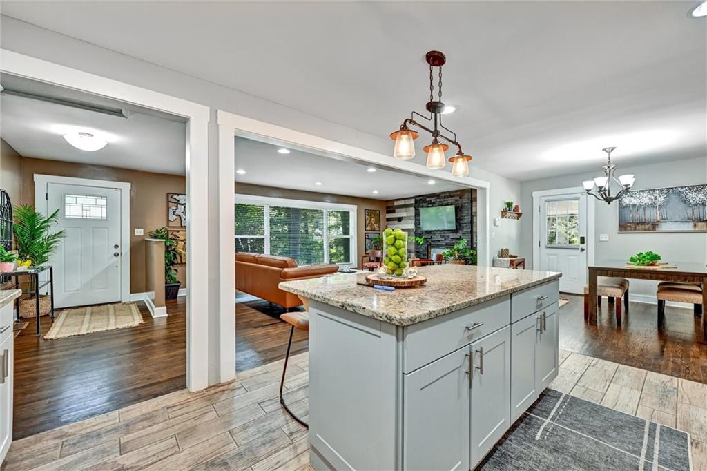 a kitchen with a stove and wooden floor