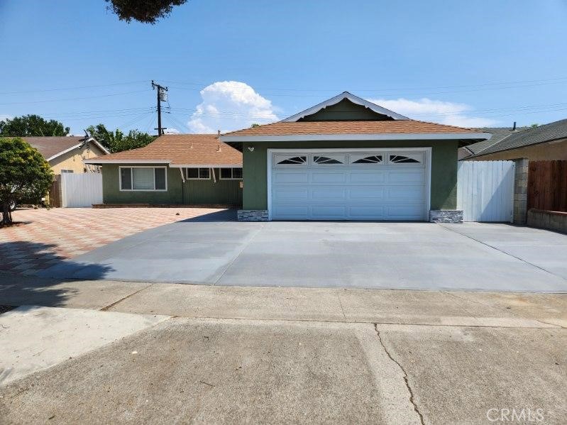 a front view of a house with yard and parking space