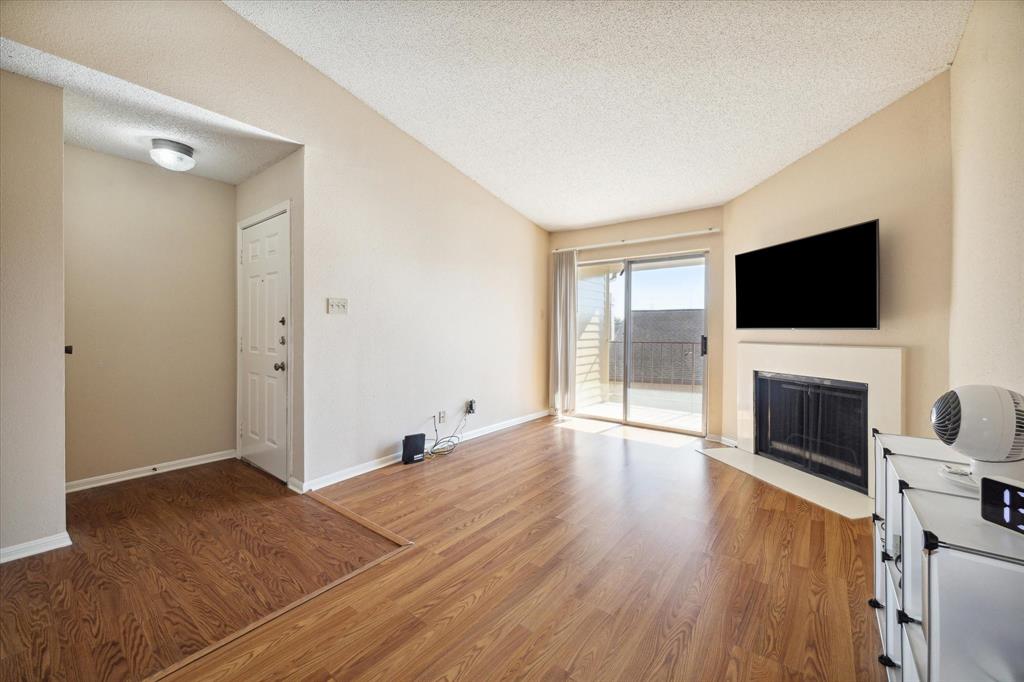 a view of a livingroom with a fireplace a window and a fireplace