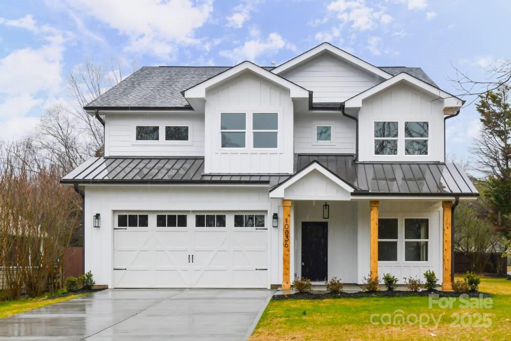 a front view of a house with yard and garage