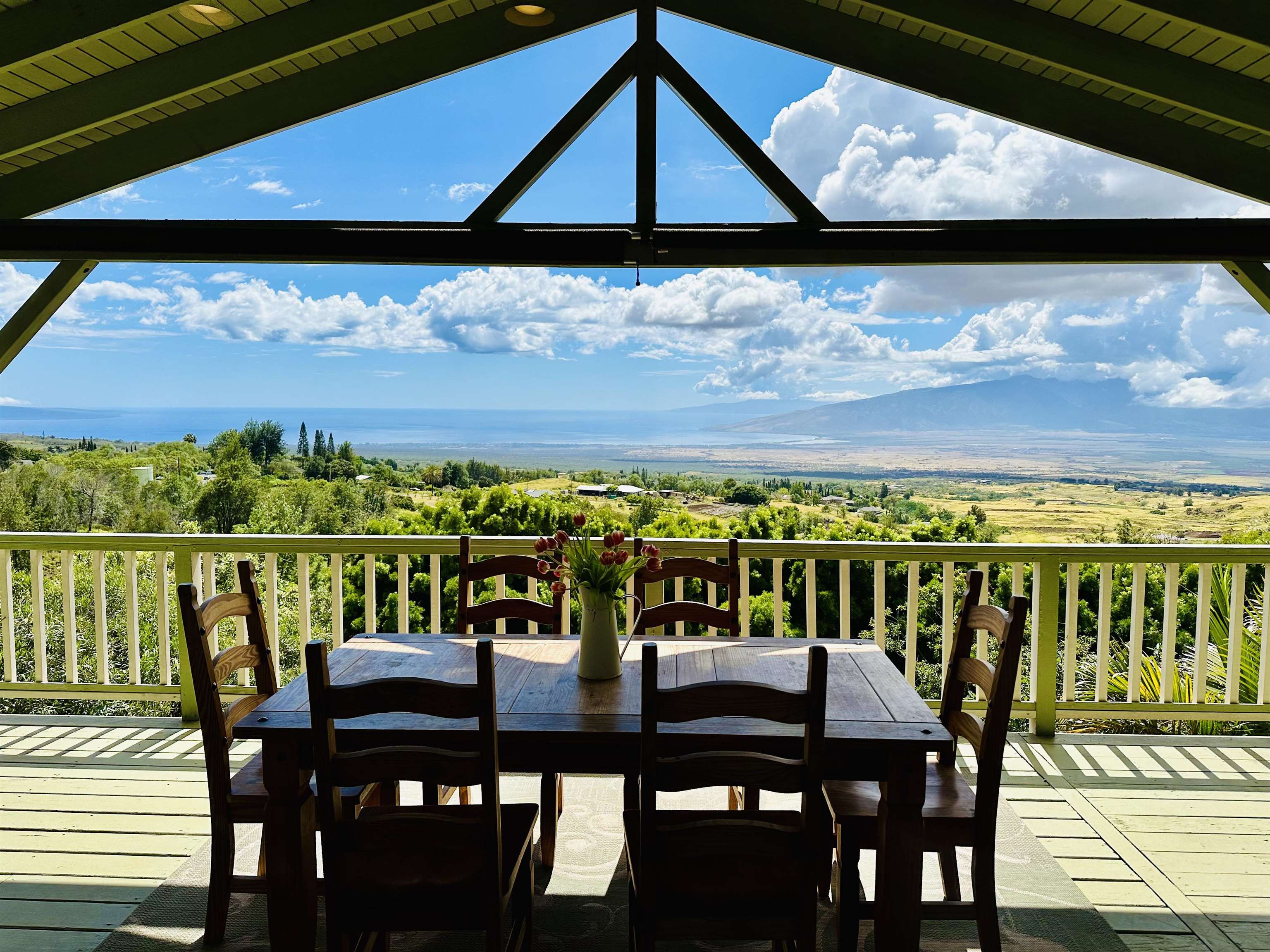 a view of a chairs and table in the balcony