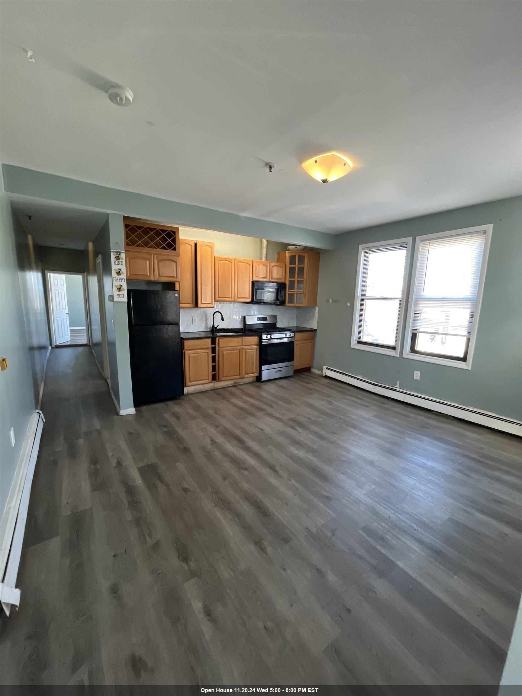 an empty room with windows wooden floor and windows