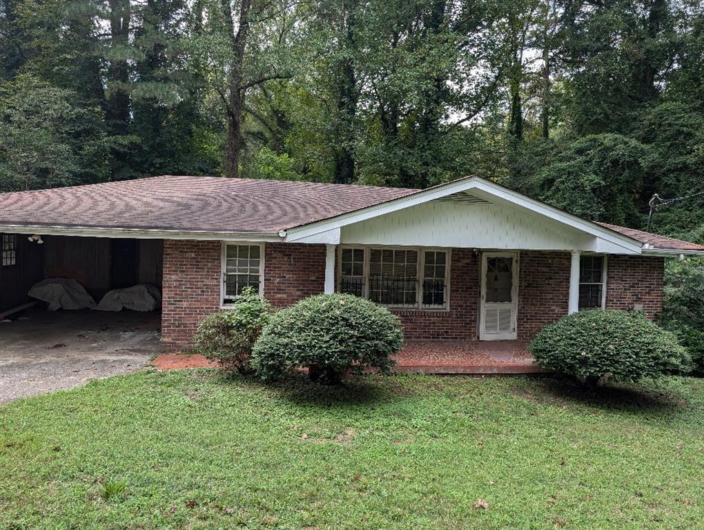 a front view of a house with a garden and porch