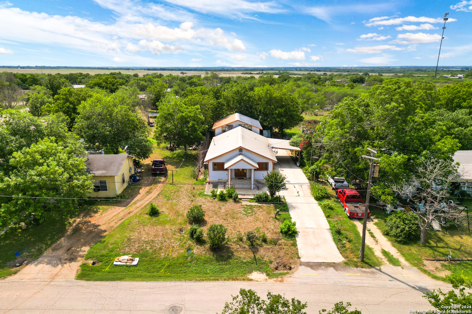 an aerial view of a house with a yard basket ball court and outdoor seating