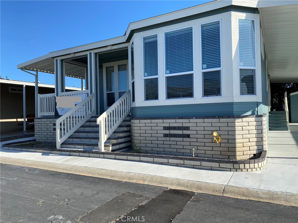 a front view of a house with stairs