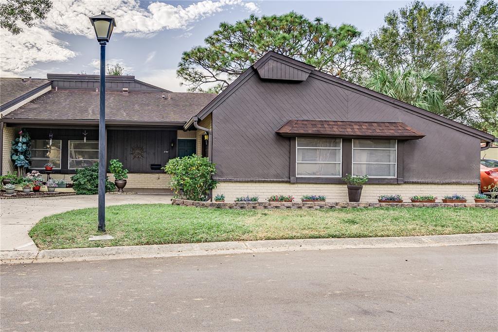 a house that has a tree in front of it