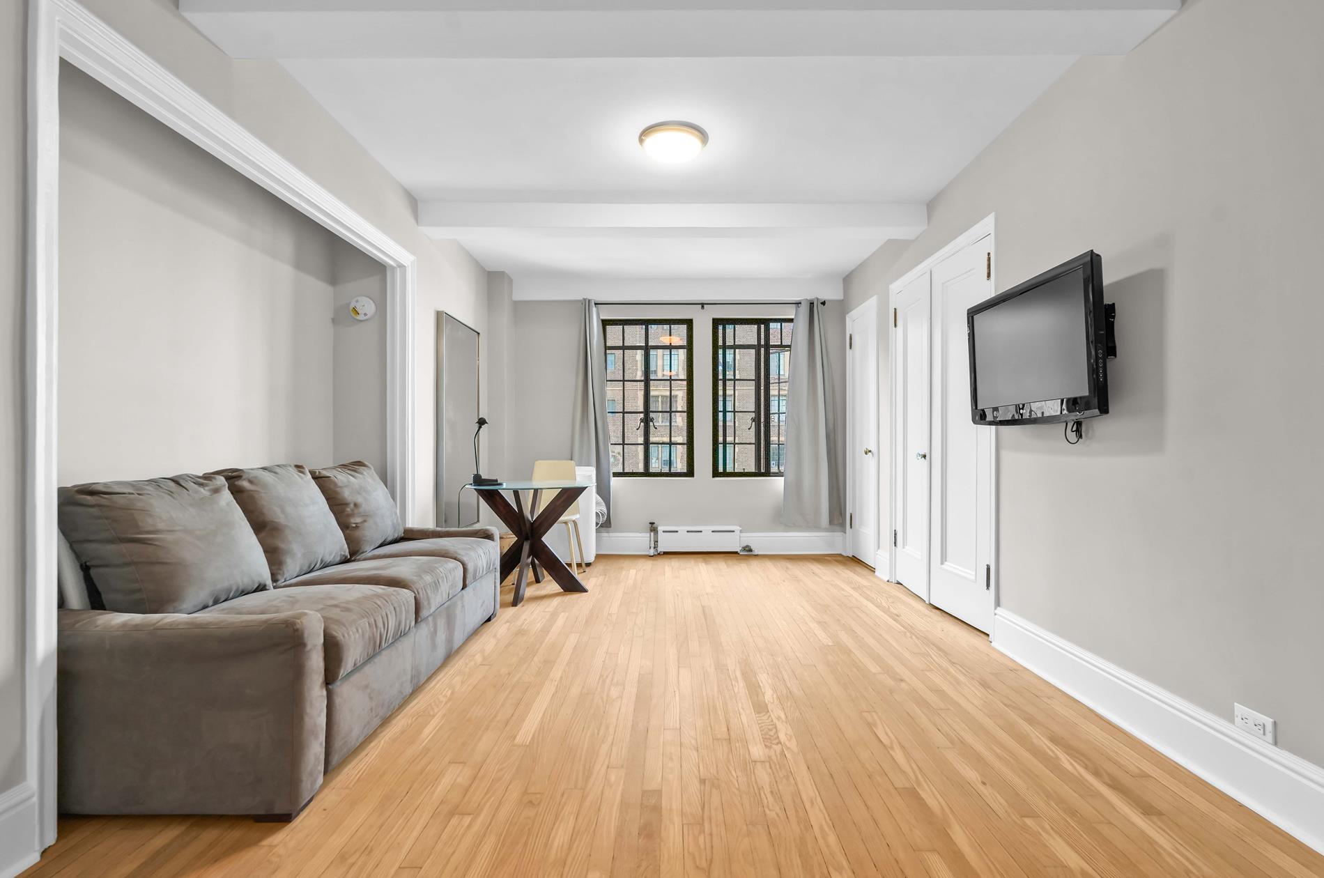 a living room with a flat screen tv and a couch