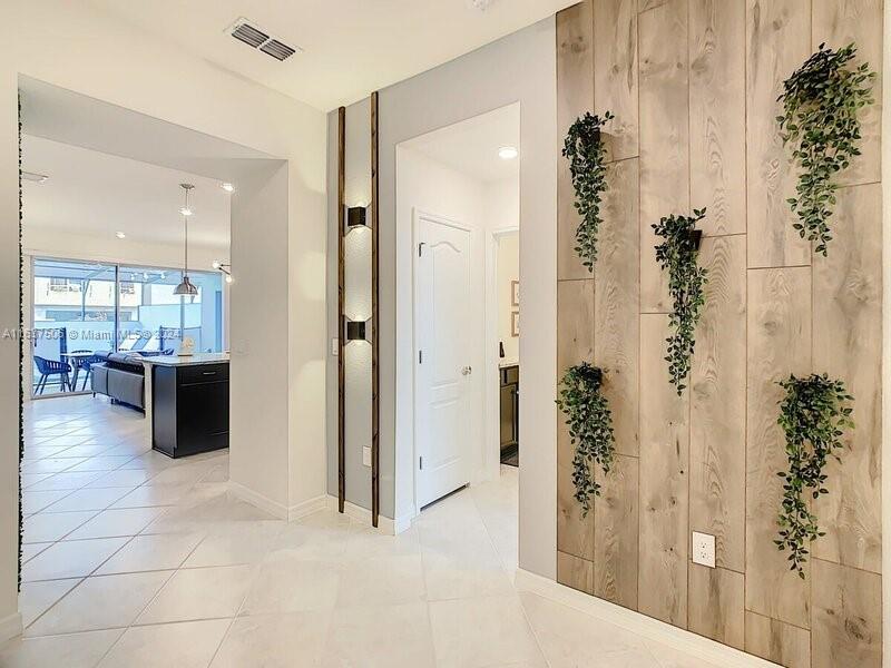 a view of a hallway with bathroom and shower