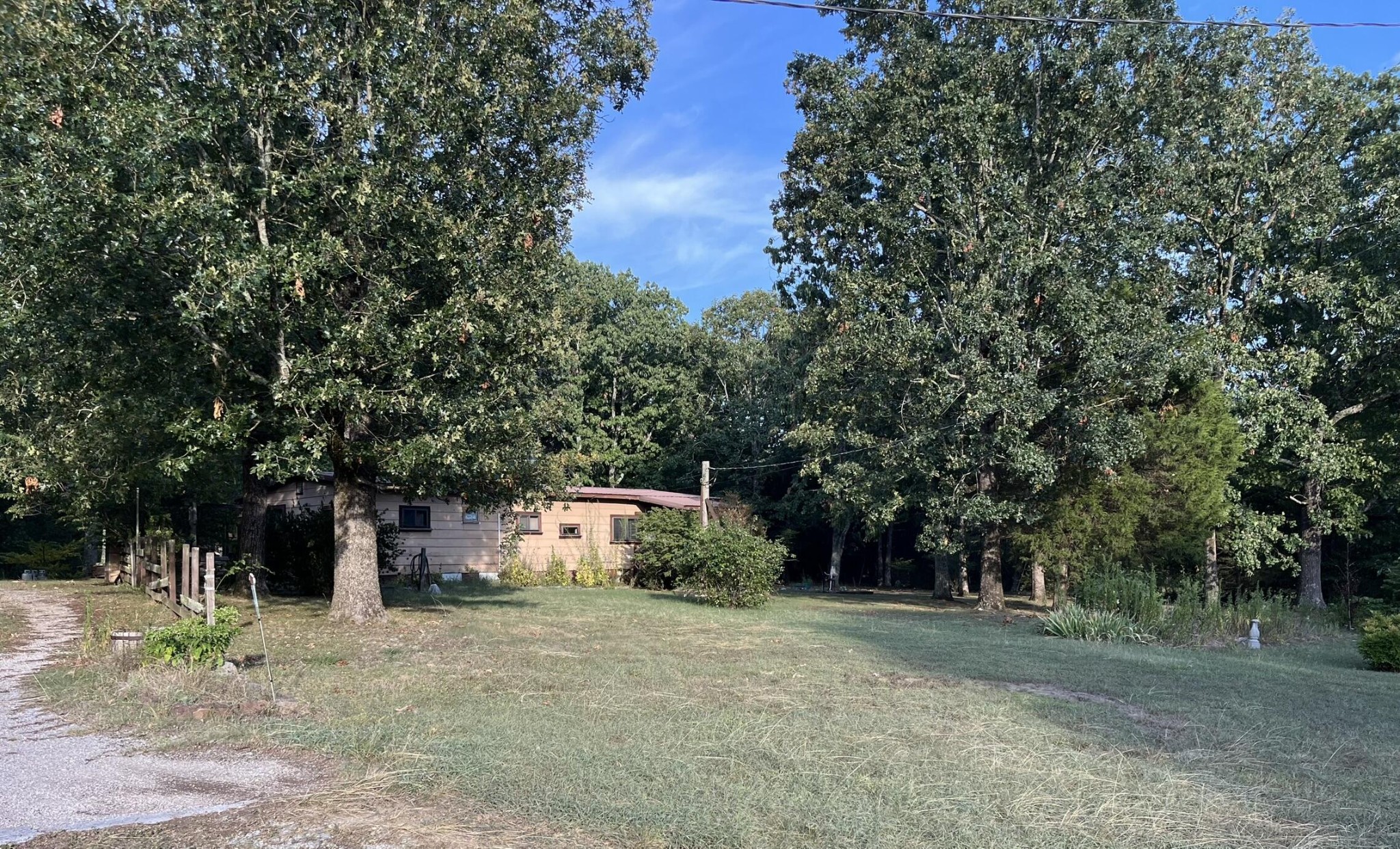 a backyard of a house with trees and outdoor space