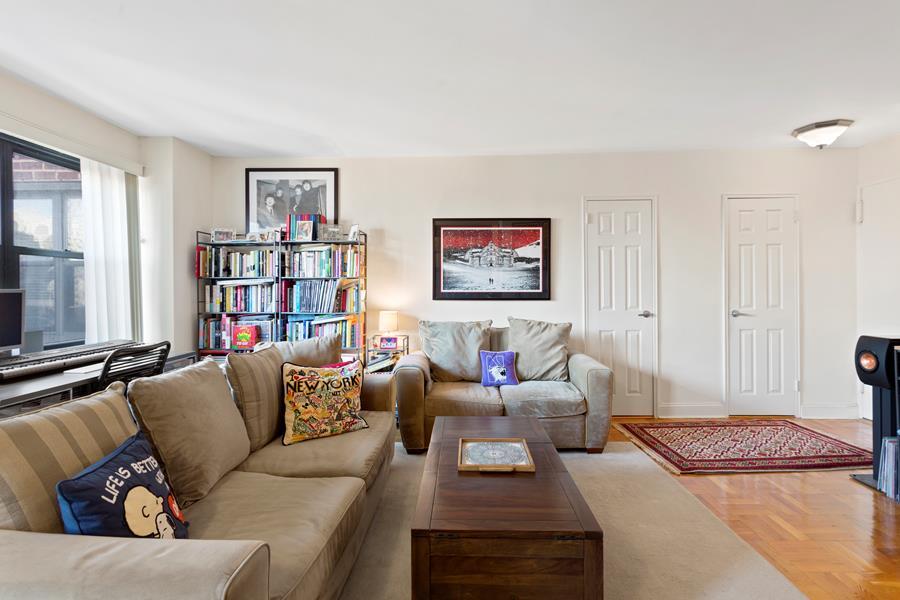 a living room with furniture and a book shelf