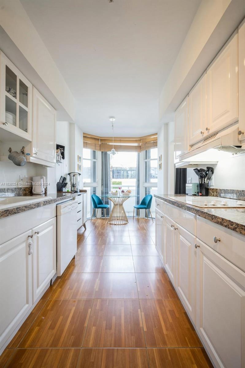 a kitchen with counter top space a sink and cabinets