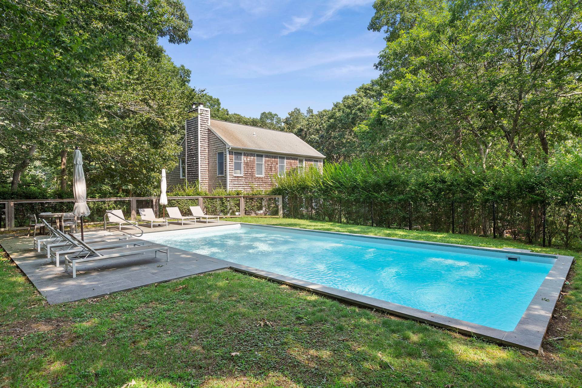 a view of a house with a yard patio and sitting area