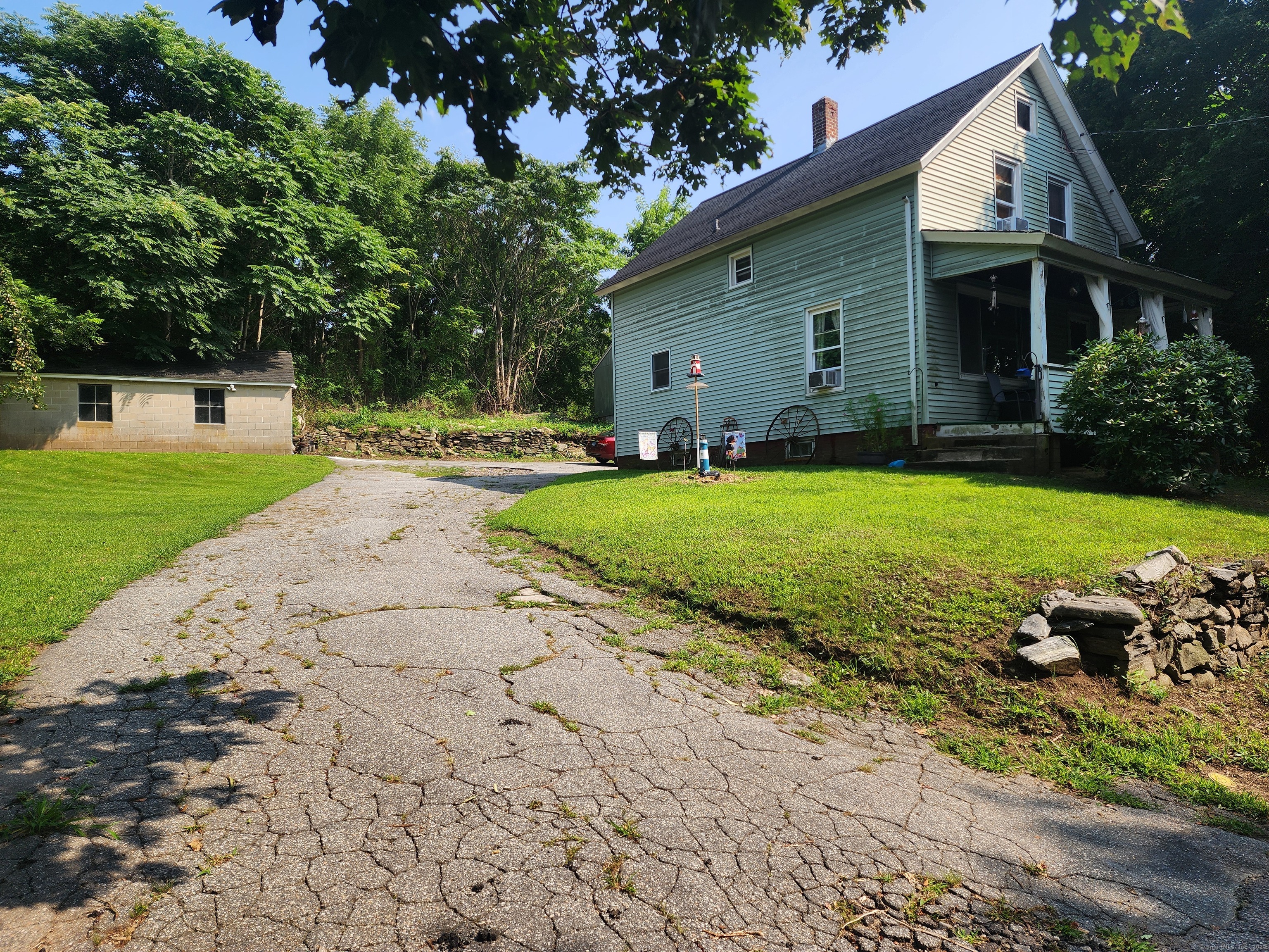 a front view of a house with a garden and yard