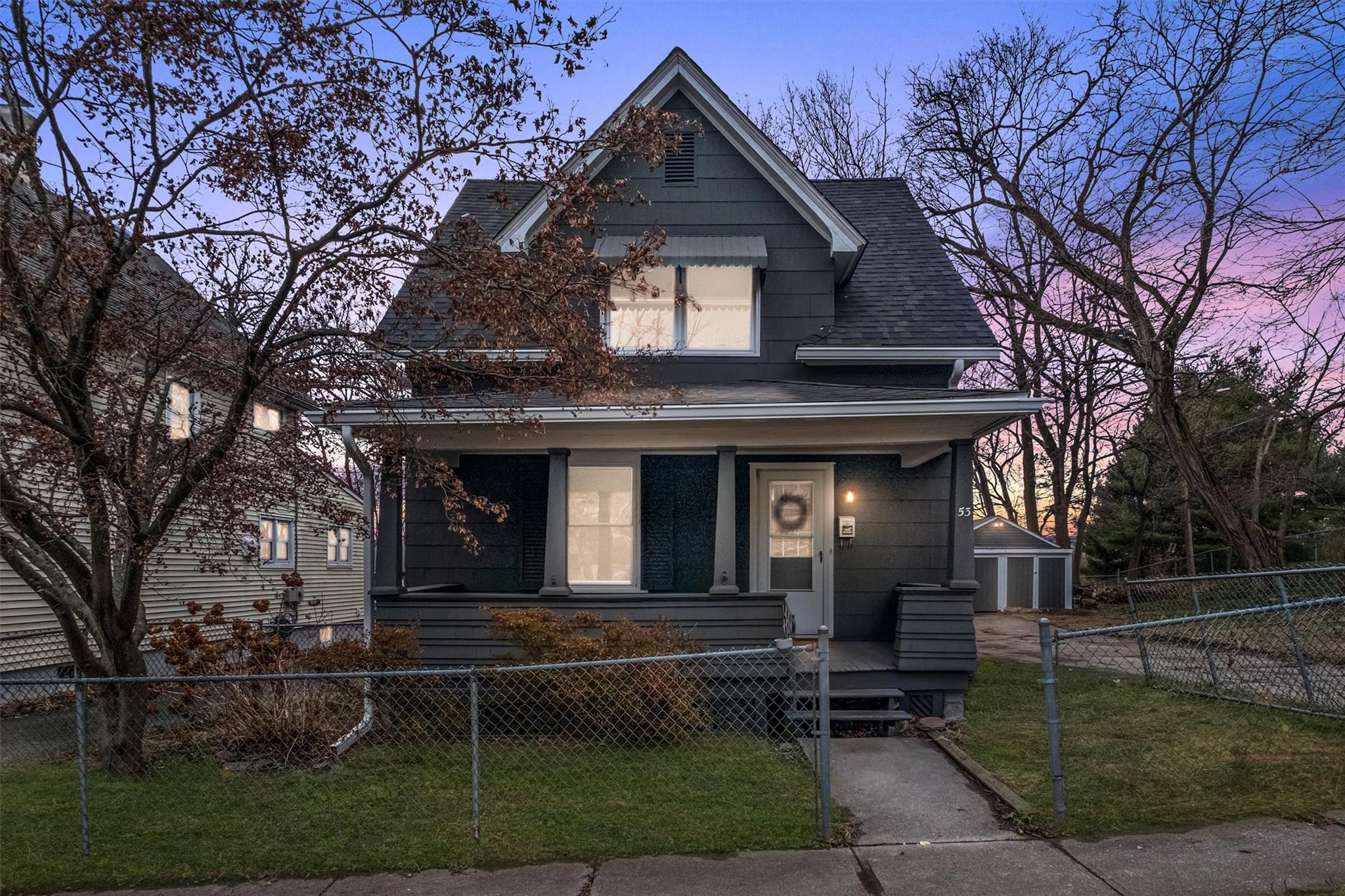 View of front of property with a lawn and a porch