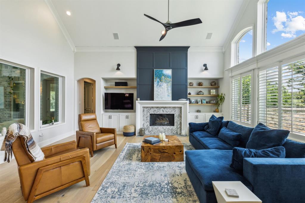 a living room with furniture fireplace and window