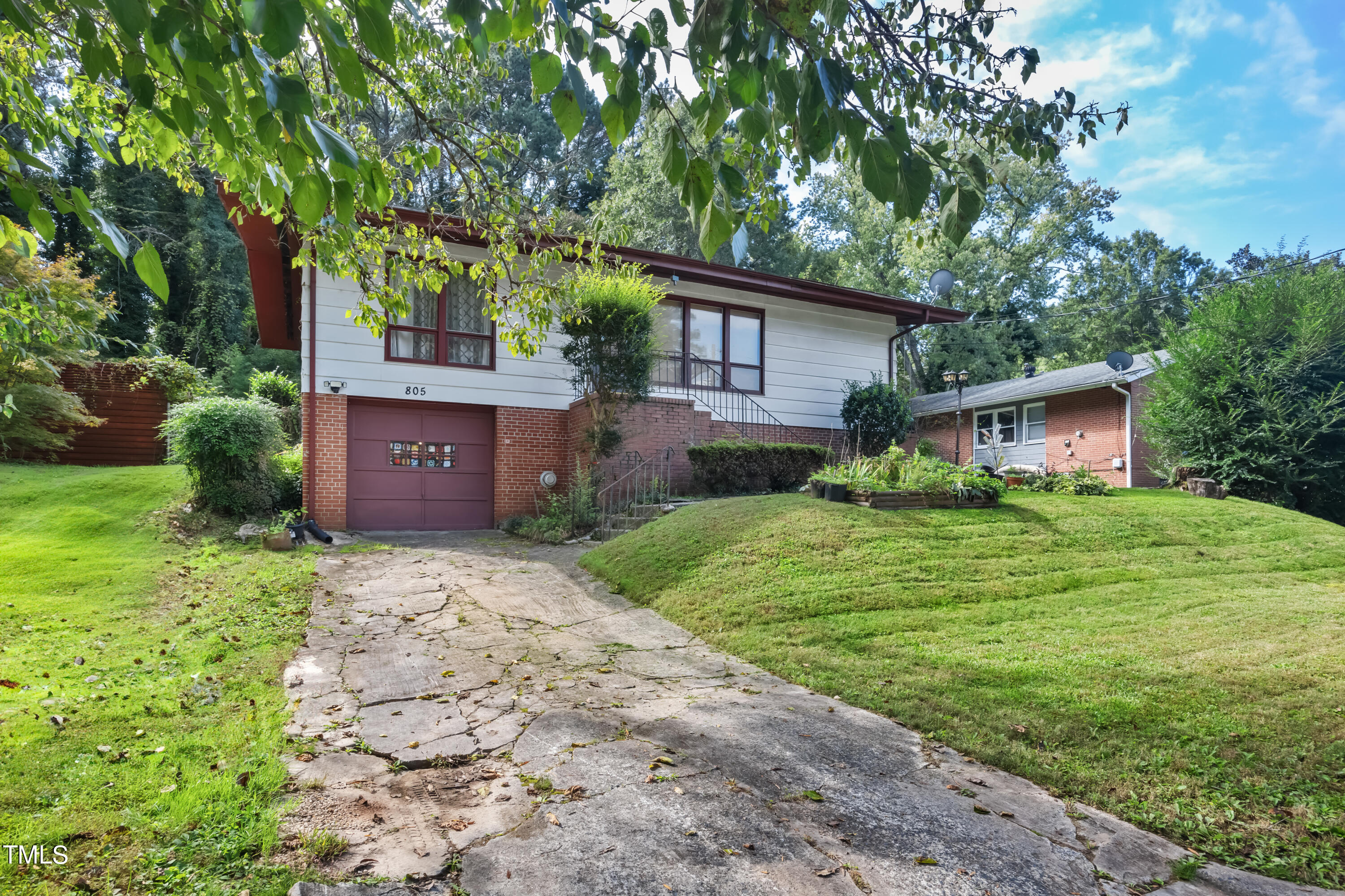 a front view of house with a garden